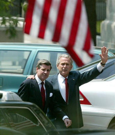 President George W. Bush walks with his arm around former US administrator in Iraq L. Paul Bremer III, to a meeting with Iraqi-Americans in the Eisenhower Old Executive Office Building across from the White House, Washington, June 30, 2004.